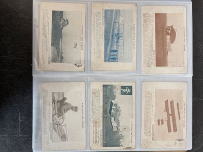 several old baseball cards are in a plastic case on a table