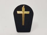 a close up of a gold cross on a black stand