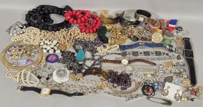 a pile of jewelry on a table with a white background