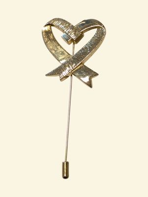 gold heart lapel pin with a bow and arrow on a white background