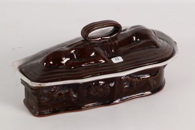 a brown and white ceramic box on a white surface