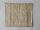 a piece of old paper with writing on it sitting on a table