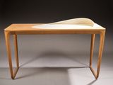 an image of a desk with a curved top and a wooden base