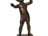 bronze statue of a boy holding a tennis racquet on a white background