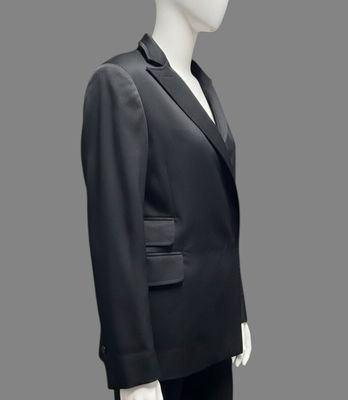 a mannequin wearing a black suit with a white shirt and black pants