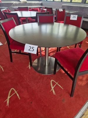 a table and chairs in a room with a red carpet