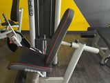 a gym equipment set up in a room with a yellow wall