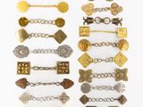 an assortment of antique and modern metal bracelets and brooches