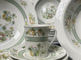 many plates and cups stacked on top of each other