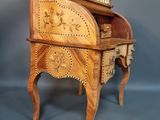 a small wooden desk with a clock on it