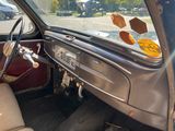 dashboard of an old car with a broken steering wheel and a broken window