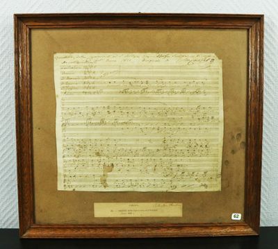 a framed piece of music paper with a piece of paper on it
