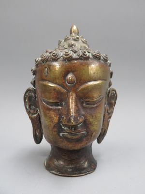 Tête de bouddha en bronze. Hauteur 16 cm (Usures)