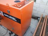 a small orange machine that is sitting on the ground