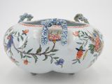 a white vase with blue and red flowers on it