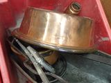 a red container with a metal pan inside of it