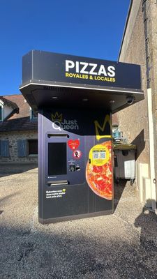 a vending machine that has a pizza on the front of it