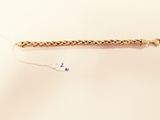 a close up of a gold bracelet with a chain attached to it