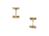 two pairs of gold cufflinks on a white background