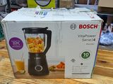 une boîte contenant un mixeur, posée sur une table en bois
