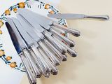 a lot of silverware on a plate on a table