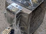 a silver toaster sitting on the floor covered in plastic
