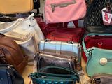 many different purses on a table in a store