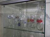a glass display case with a lot of bottles on it