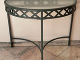 a table with a glass top on a tiled floor