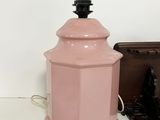 a pink lamp that is next to a wooden box