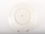 underside view of a white plate with a black and white design
