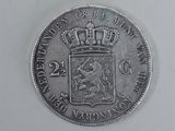 a close up of a silver coin with a crown on it