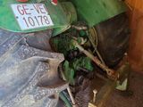 a green tractor with a sign on the back of it