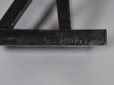 a close up of a metal object on a white surface