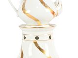 a white and gold tea pot on a stand
