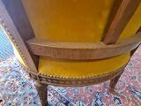 a yellow chair that is sitting on a rug