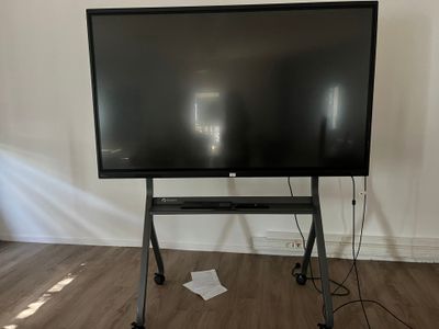 a flat screen tv sitting on a stand in a room
