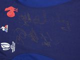 a blue shirt with a red rooster on it