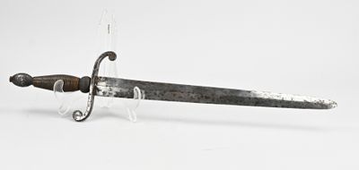 a very old sword that is on display on the table