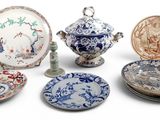 many different types of plates and bowls on the table