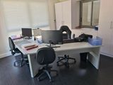 a desk with two computer monitors and a laptop on it