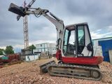 a picture of a small excavator sitting on top of a pile of rubble