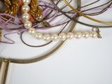 many different types of necklaces and bracelets on the table
