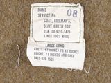 a piece of paper on the ground with a tag attached to it
