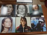 many pictures of a woman on a table with a laptop