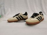 vintage adidas sneakers with black and white stripes and gum soles