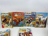 several children ' s books are lined up on a white surface