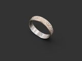 a close up of a silver ring on a black background