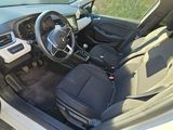 the interior of a car with the door open and the driver ' s seat down