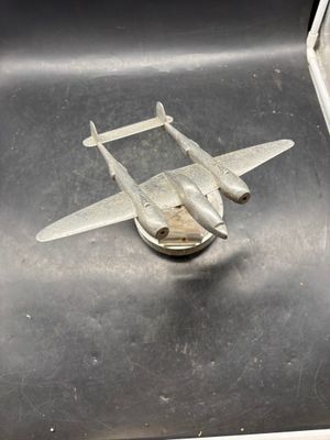 a metal model of a plane sitting on a table